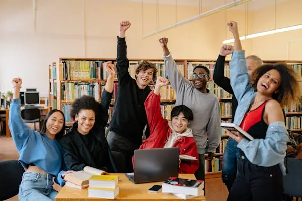 Students cheering together in a campus library